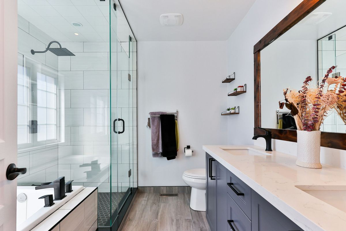 Deep-cleaned bathroom with spotless glass shower and polished fixtures