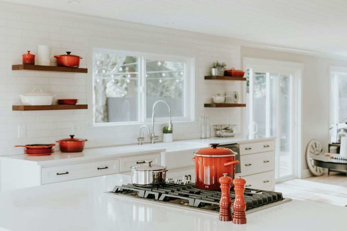 Clean kitchen with polished counters and open shelving