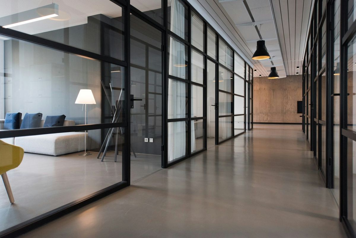 Clean modern office corridor with glass partitions