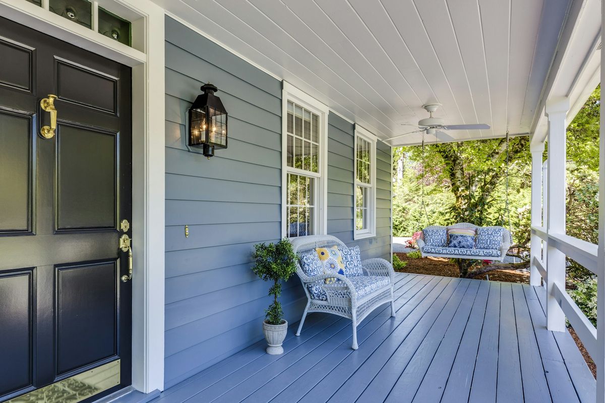 Clean covered front porch with ceiling fan on a Florida home